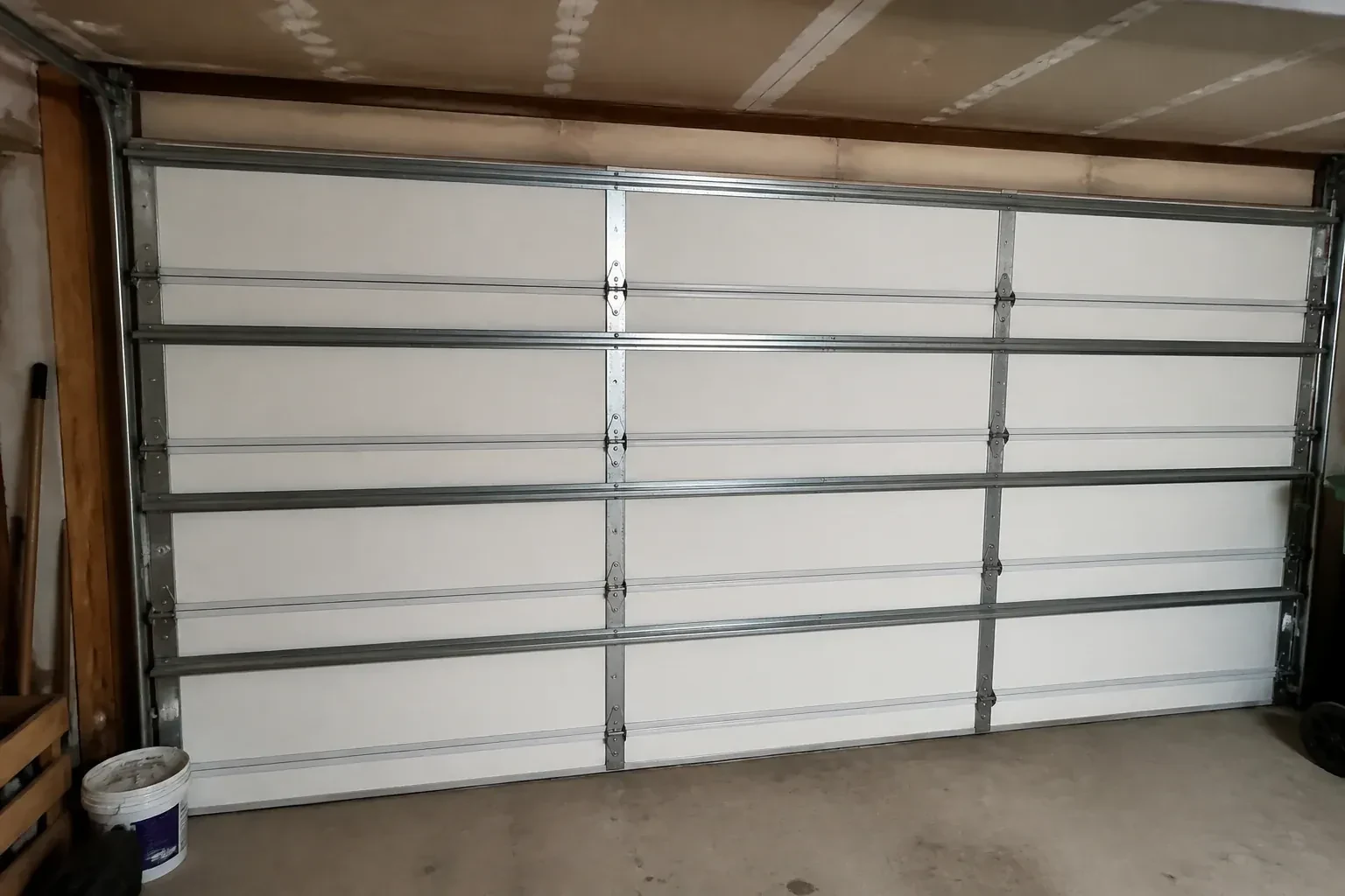 Interior of a closed sectional door with horizontal metal reinforcement struts. — Wind-Rated Garage Door Replacement, Mapleton